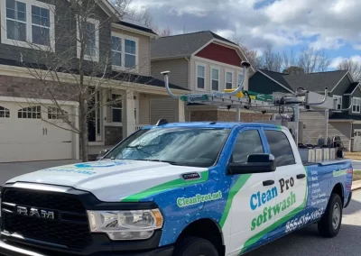 A Clean Pro Softwash truck is parked on a residential street in front of suburban houses.