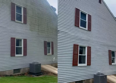 Side-by-side view of a house before and after cleaning, showing dirty and clean siding with red shutters.